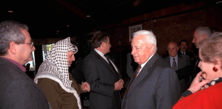 Arafat meets Sharon at the Wye Conference.